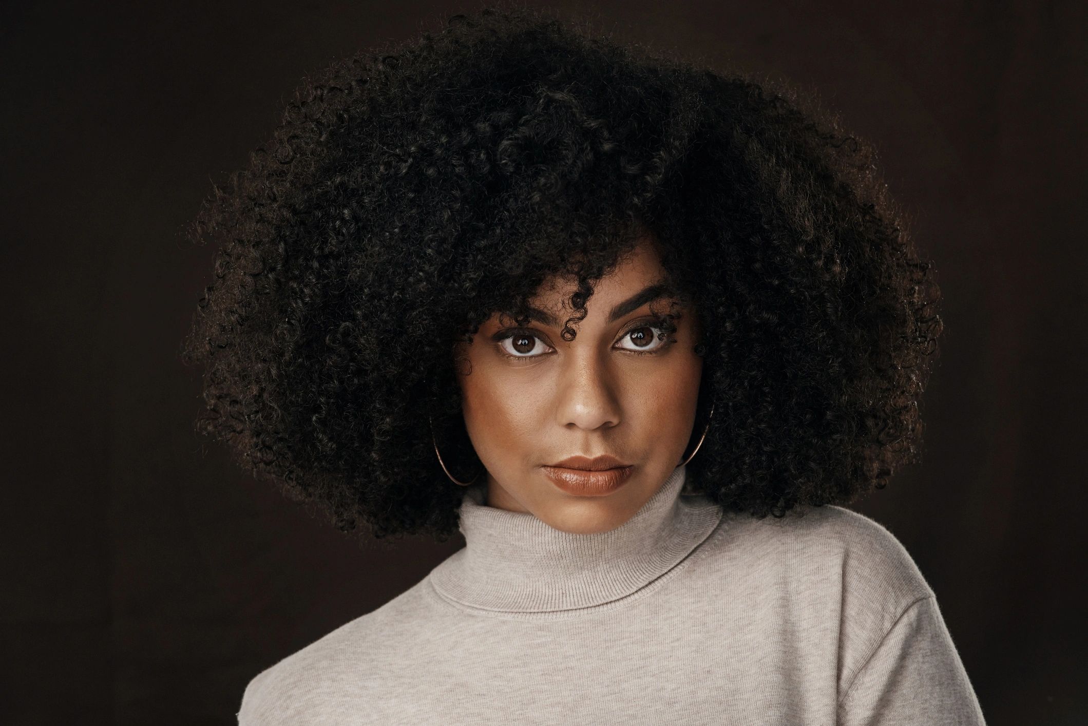 Studio portrait of a woman against a dark background