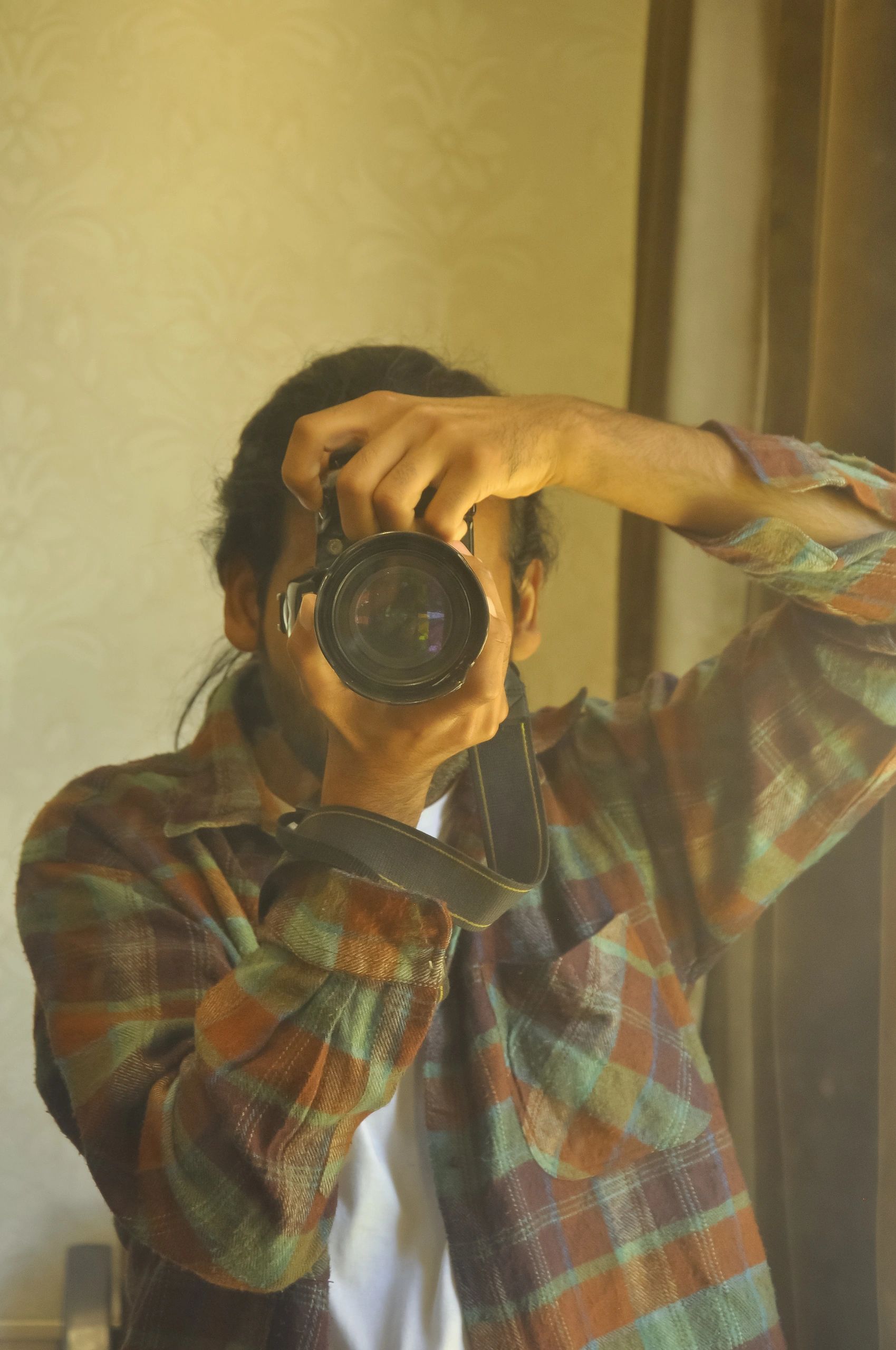 Photographer looking through a DSLR camera in a mirror