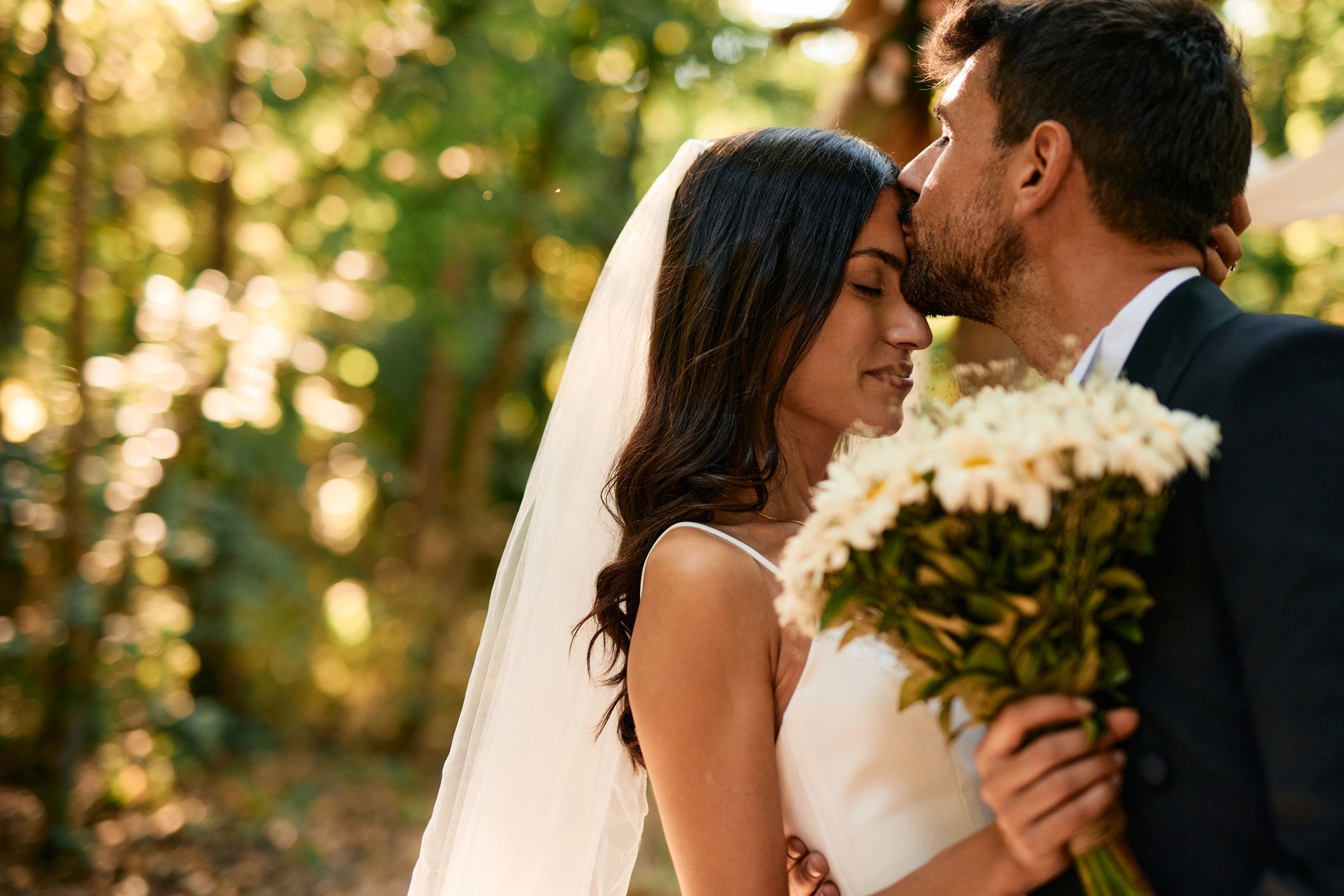Wedding couple during ceremony in the woods